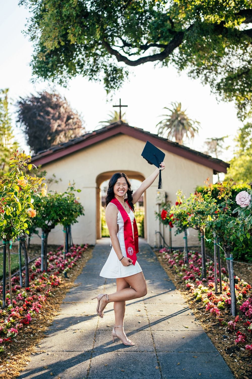 Santa Clara University graduate posing on campus during golden hour in the Bay Area