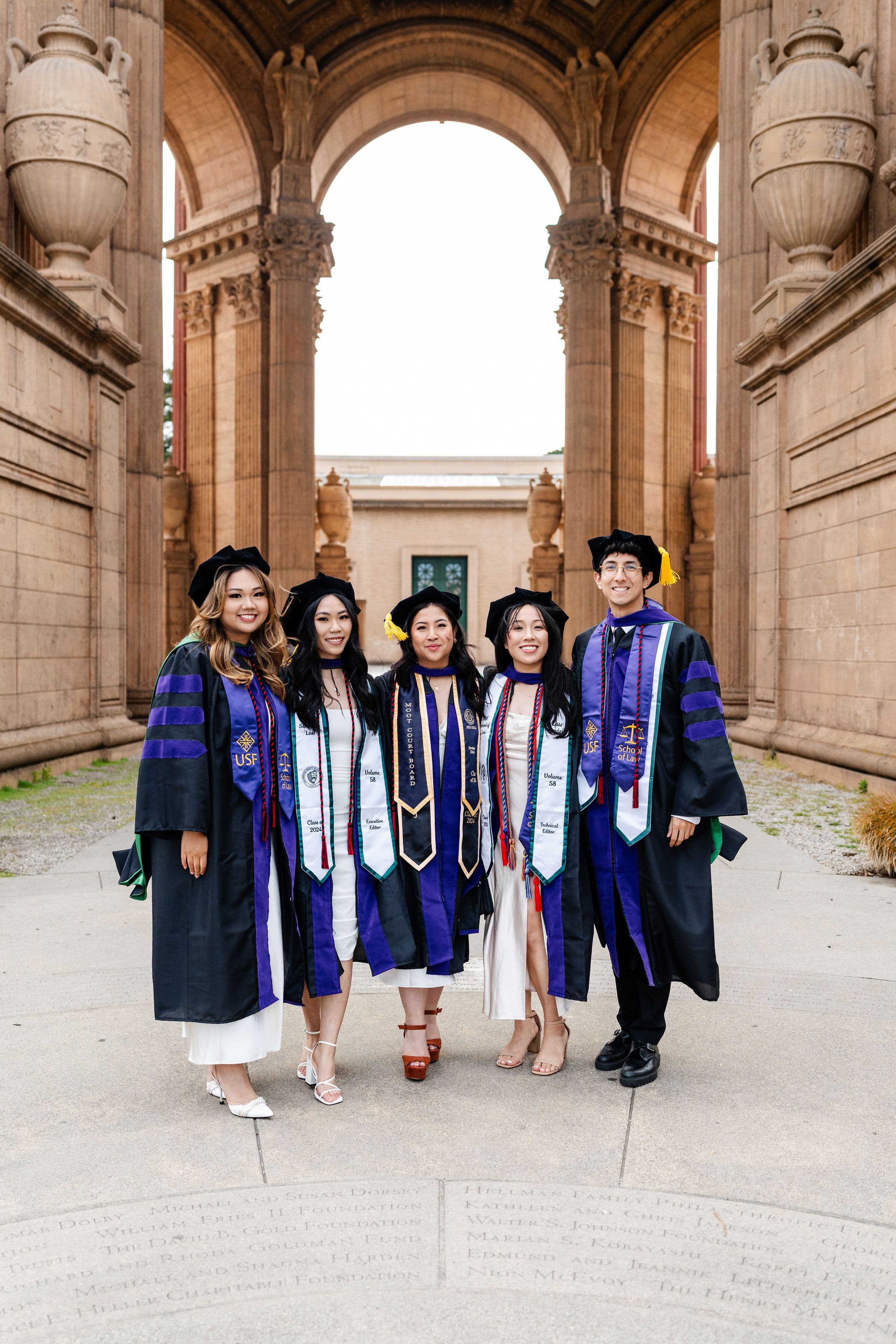 UC Law graduate poses for a golden hour portrait at the Palace of Fine Arts in San Francisco
