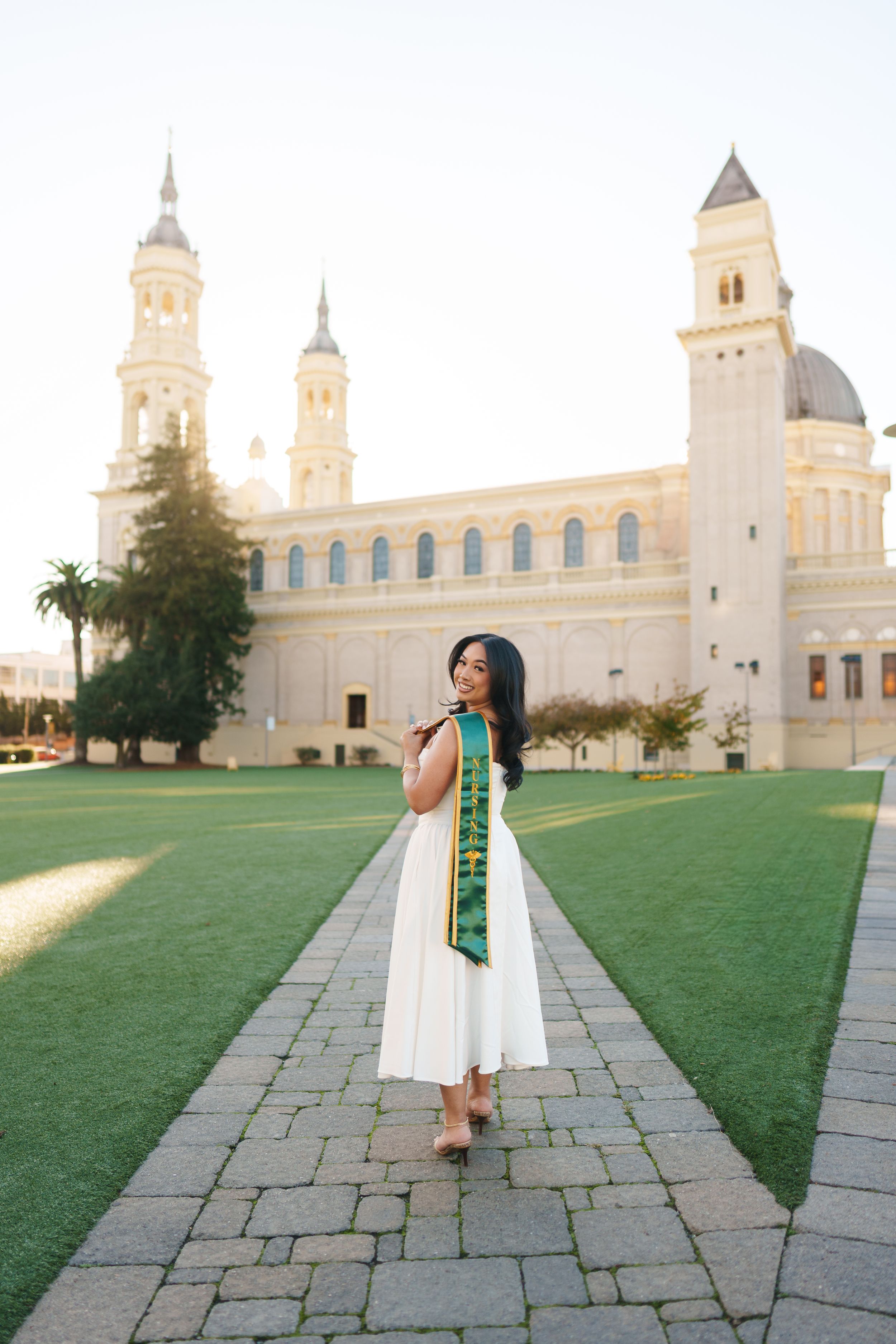 USF graduate posing on campus during golden hour for a Bay Area graduation portrait
